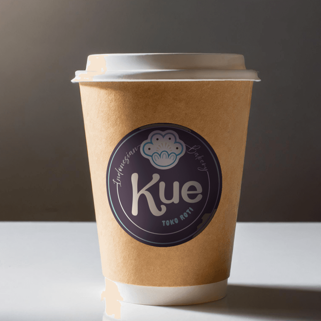 Takeaway coffee cup branded with the purple Kue logo