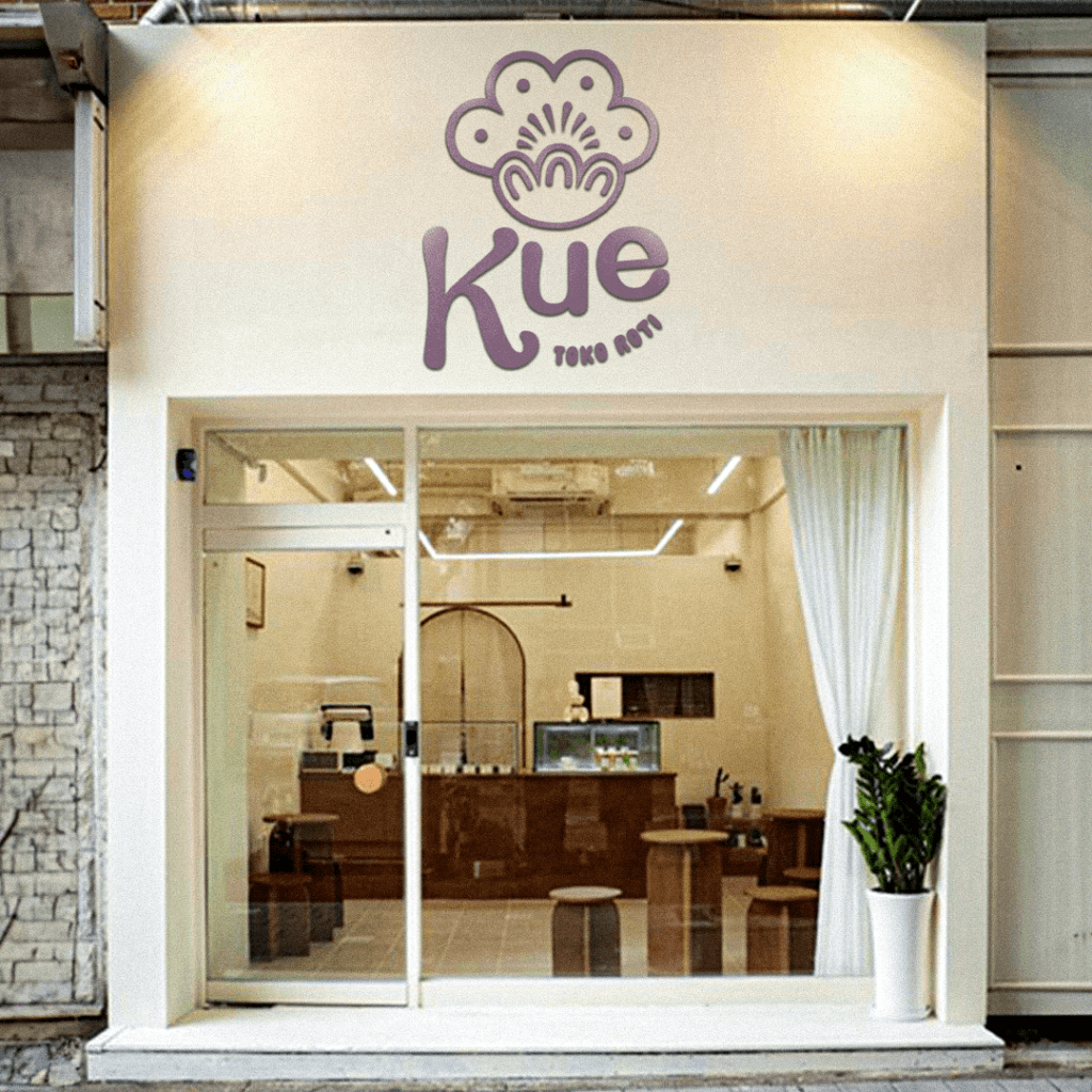 Mockup of the white Kue bakery storefront with the logo above the door